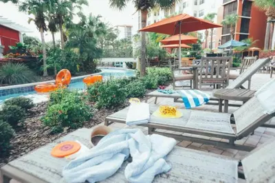 a patio with a picnic table and an umbrella at Studio Apt in Orlando resort onsite pools, golf, arcades, cabanas etc. in Orlando