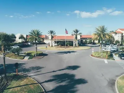 an empty street in front of a building with palm trees at Studio Apt in Orlando resort onsite pools, golf, arcades, cabanas etc. in Orlando