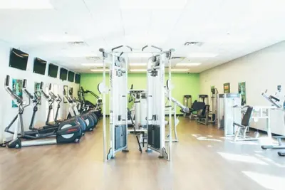 a gym with treadmills and cardio equipment in a room at Studio Apt in Orlando resort onsite pools, golf, arcades, cabanas etc. in Orlando