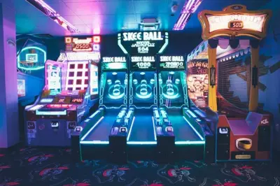 a video game room with arcade machines and signs at Studio Apt in Orlando resort onsite pools, golf, arcades, cabanas etc. in Orlando