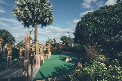 a miniature golf course in a park with a palm tree at Near Disney 1BD vacation condo in beautiful resort with lots of amenities in Orlando