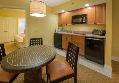 a kitchen with a table and chairs in a room at Near Disney 1BD vacation condo in beautiful resort with lots of amenities in Orlando