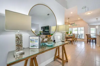a dining room and living room with a large mirror at 5 Mi to Disney World Spacious Kissimmee Home! in Kissimmee