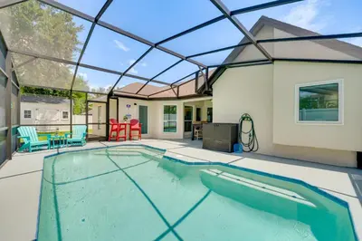a swimming pool in a house with a glass ceiling at 5 Mi to Disney World Spacious Kissimmee Home! in Kissimmee