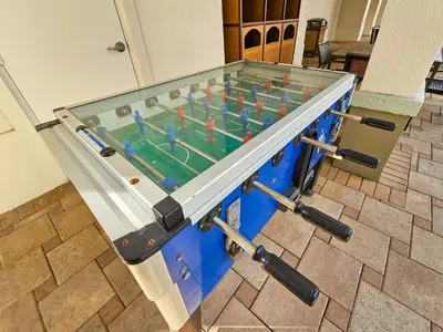 a foosball table with a glass top at 1 Bedroom - Grand Suite 5 min to Universal, I-drive & Outlets in Orlando