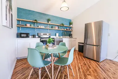 a kitchen with a table and chairs and a refrigerator at New APT 15Min Drive Disney and Airport - Parks KingBed Pets in Kissimmee