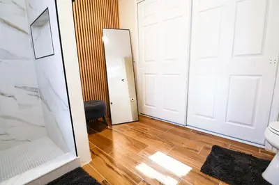 a bathroom with a white door and a mirror at New APT 15Min Drive Disney and Airport - Parks KingBed Pets in Kissimmee