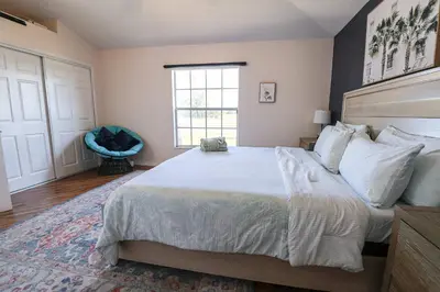 a bedroom with a large bed and a window at New APT 15Min Drive Disney and Airport - Parks KingBed Pets in Kissimmee