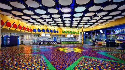 a large room with colorful floors and a large ceiling at Disney's Pop Century Resort in Orlando