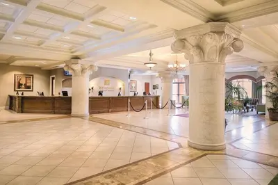 a large lobby with columns and a bar in the background at Beautiful Resort in Bonnet Creek 1BD Deluxe near Walt Disney World in Orlando