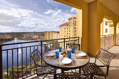 a table on a balcony with a view of the water at Beautiful Resort in Bonnet Creek 1BD Deluxe near Walt Disney World in Orlando