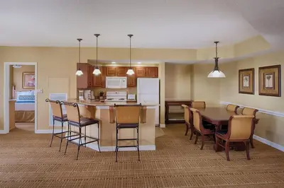 a kitchen and dining room with a table and chairs at Beautiful Resort in Bonnet Creek 2BD Deluxe near Walt Disney World in Orlando