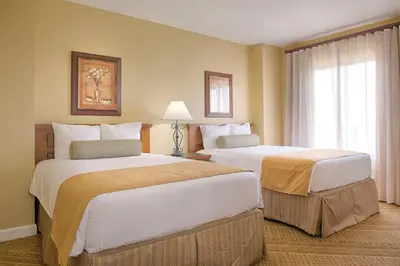 a hotel room with two beds and a window at Beautiful Resort in Bonnet Creek 2BD Deluxe near Walt Disney World in Orlando
