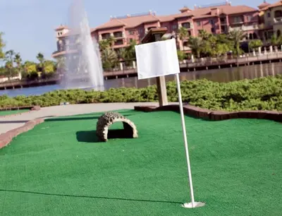 a putting green with a white flag and a fountain at Beautiful Resort in Bonnet Creek 2BD Deluxe near Walt Disney World in Orlando