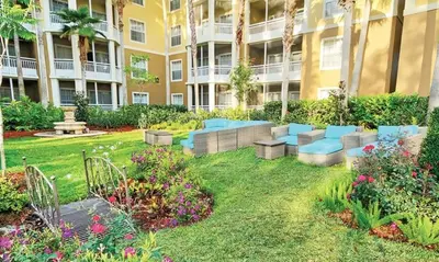 a garden in the courtyard of a apartment building at Beautiful Hotel of Cypress Palms 1BD near Kissimmee Lakefornt Park in Kissimmee
