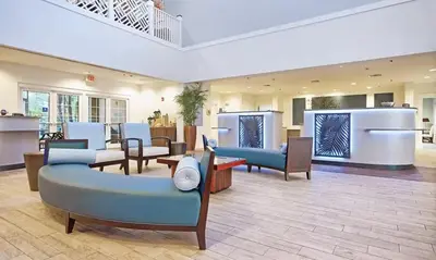 a lobby with couches and chairs in a building at Beautiful Hotel of Cypress Palms 2BD in Kissimmee