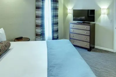 a hotel room with a bed and a television at Beautiful Resort in Star Island 2BD near at Lake Cecile in Kissimmee