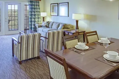 a living room with a table and a couch at Beautiful Resort in Star Island 2BD near at Lake Cecile in Kissimmee