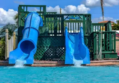 a blue water slide in a pool at Diamond - Orbit One Vacation Villas- 2BD in Orlando
