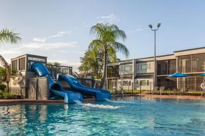 a water slide in a pool at a resort at Diamond - Orbit One Vacation Villas- 2BD in Orlando