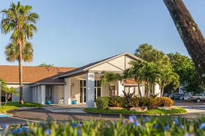 a building with palm trees in a parking lot at Diamond - Orbit One Vacation Villas- 2BD in Orlando