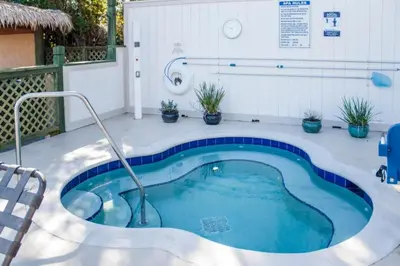 a swimming pool with a hot tub on a patio at Diamond Bryans Spanish Cove 2BD in Orlando