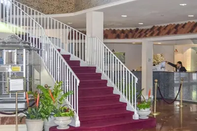 a white staircase in a building with potted plants at Diamond - Cypress Pointe Resort - St in Orlando