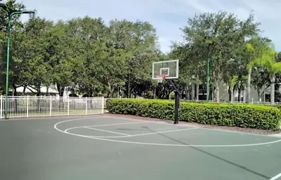 a basketball hoop in a park with trees at Diamond - Cypress Pointe Resort - St in Orlando