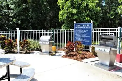 a park with a fence and a bench and a sign at Diamond - Cypress Pointe Resort - St in Orlando