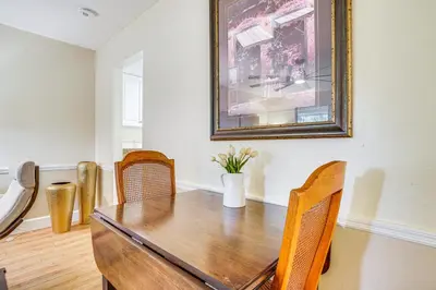 a dining room with a wooden table and chairs at Half-Mi to Riverwalk Charming Sanford Retreat! in Sanford