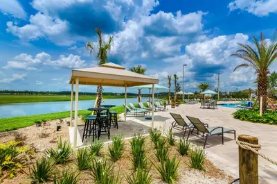 a pavilion with chairs and tables next to a pool at 5003 Windermere Avenue in Kissimmee