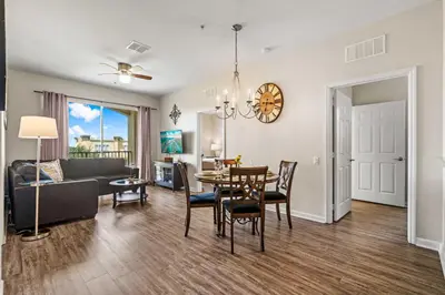 a living room and dining room with a table and chairs at 4802 Cayview Avenue 308 in Orlando