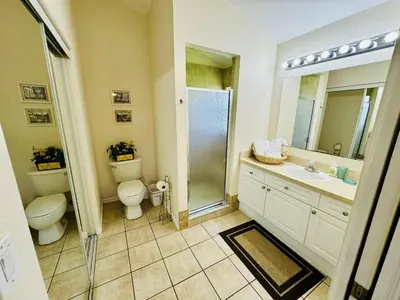a bathroom with a toilet and a sink and a shower at 43 Vacation Home With Private Pool Located At Formosa Gardens!! in Orlando