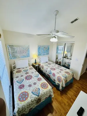a bedroom with two beds and a ceiling fan at 43 Vacation Home With Private Pool Located At Formosa Gardens!! in Orlando