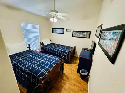 a bedroom with two beds and a ceiling fan at 43 Vacation Home With Private Pool Located At Formosa Gardens!! in Orlando