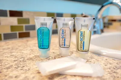 a group of three bottles of cleaning products on a counter at Relaxing Retreat with Pool and Movie Theater in Orlando