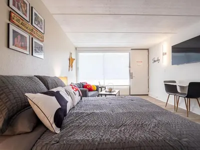 a bedroom with a bed and a living room at Orlando 1BR Disney Themed Vacation with pool view Next to Disney in Kissimmee