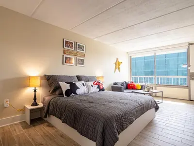 a bedroom with a large bed and a large window at Orlando 1BR Disney Themed Vacation with pool view Next to Disney in Kissimmee