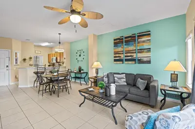 a living room with a couch and a table at Terra Verde Townhouse with Patio in Kissimmee