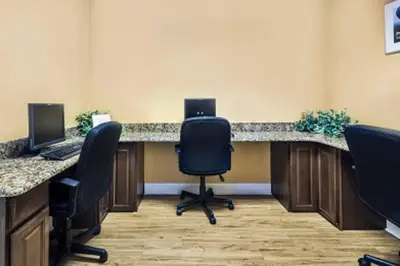 an office with two desks with chairs and two computers at 7BD 5BA w Pool Spa Home 10 mins away to Disney in Kissimmee