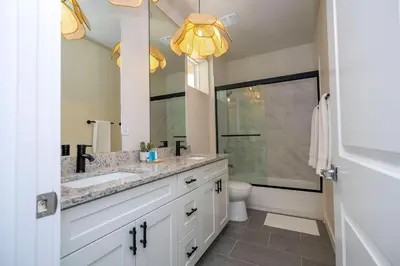 a bathroom with a sink and a mirror at Welcome to The Lion Nest. A Savanna-Inspired Oasis in Orlando