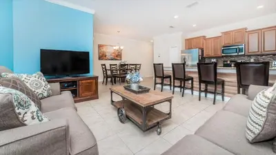 a living room with a couch and a tv at Storey Lake *10 mim -> Disney* 4Q/3Ba in Kissimmee