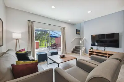 a living room with a couch and a tv at 2 Suítes c/ Jacuzzi • 10min da Disney in Kissimmee