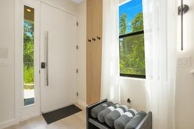 a living room with a couch and a window at Luxury Villa Near Disney and Universal in Kissimmee
