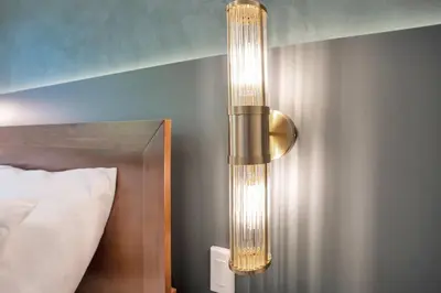 a large light hanging from a wall next to a bed at Luxury Villa Near Disney and Universal in Kissimmee