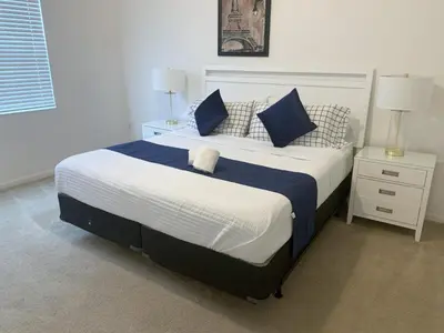 a bedroom with a large bed with blue and white pillows at Magic Kingdom Villa - Private Master Bedrooms in Kissimmee