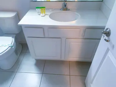 a white bathroom with a sink and a toilet at Magic Kingdom Villa - Private Master Bedrooms in Kissimmee