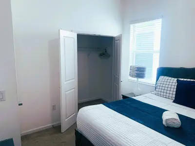 a bedroom with a blue and white bed and a window at Magic Kingdom Villa - Private Master Bedrooms in Kissimmee