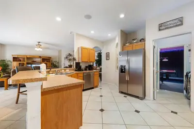 a large kitchen with a stainless steel refrigerator at Waterslide 6 bed Lux Villa Emerald Island in Kissimmee