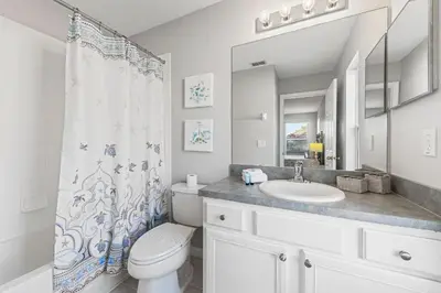 a white bathroom with a sink and a toilet at 6 Bedroom Villa - Emerald Island Retreat in Kissimmee